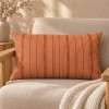 Funda de cojín rectangular PALOMA naranja 30 x 50 cm con relleno, sobre un sillón