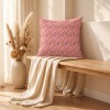 HINDI pink square scatter cushion 40 x 40 cm on a bench