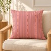 PALOMA pink square scatter cushion 50 x 50 cm on an armchair