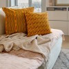 HINDI yellow square cushion cover 40 x 40 cm, filled, on a sofa with another cushion from the collection