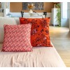 HINDI pink square cushion cover 40 x 40 cm, filled, on a sofa with another cushion from the collection