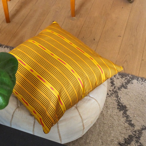 PALOMA yellow square cushion cover 40 x 40 cm, filled, on a pouffe
