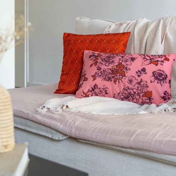 AIMI pink rectangular scatter cushion 30 x 50 cm on a sofa with another cushion from the collection