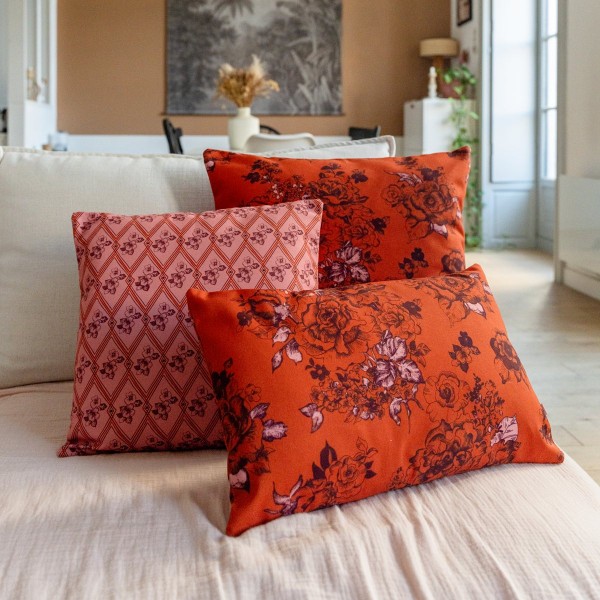 AIMI orange square scatter cushion 40 x 40 cm on a sofa with other cushions from the collection
